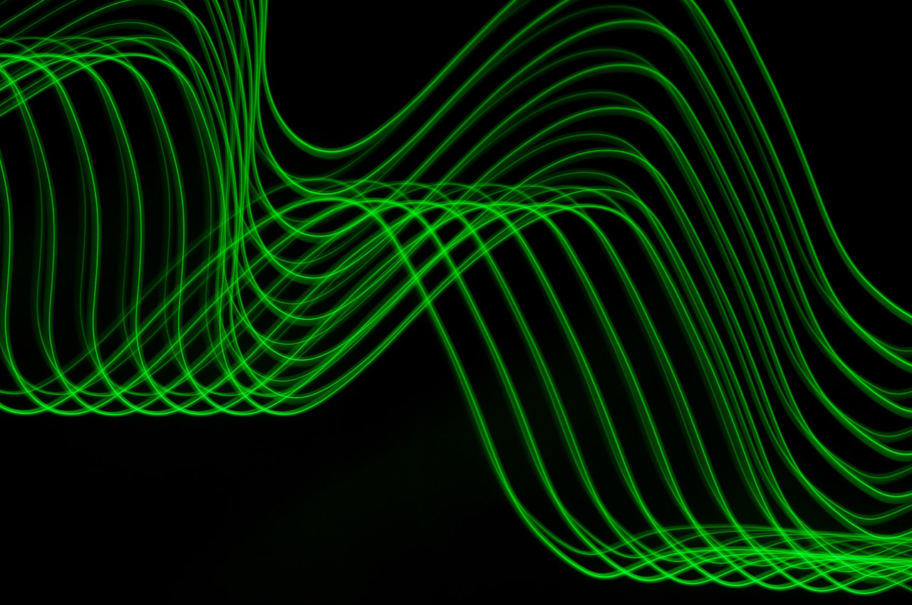 a series of wavy green lines on a black background